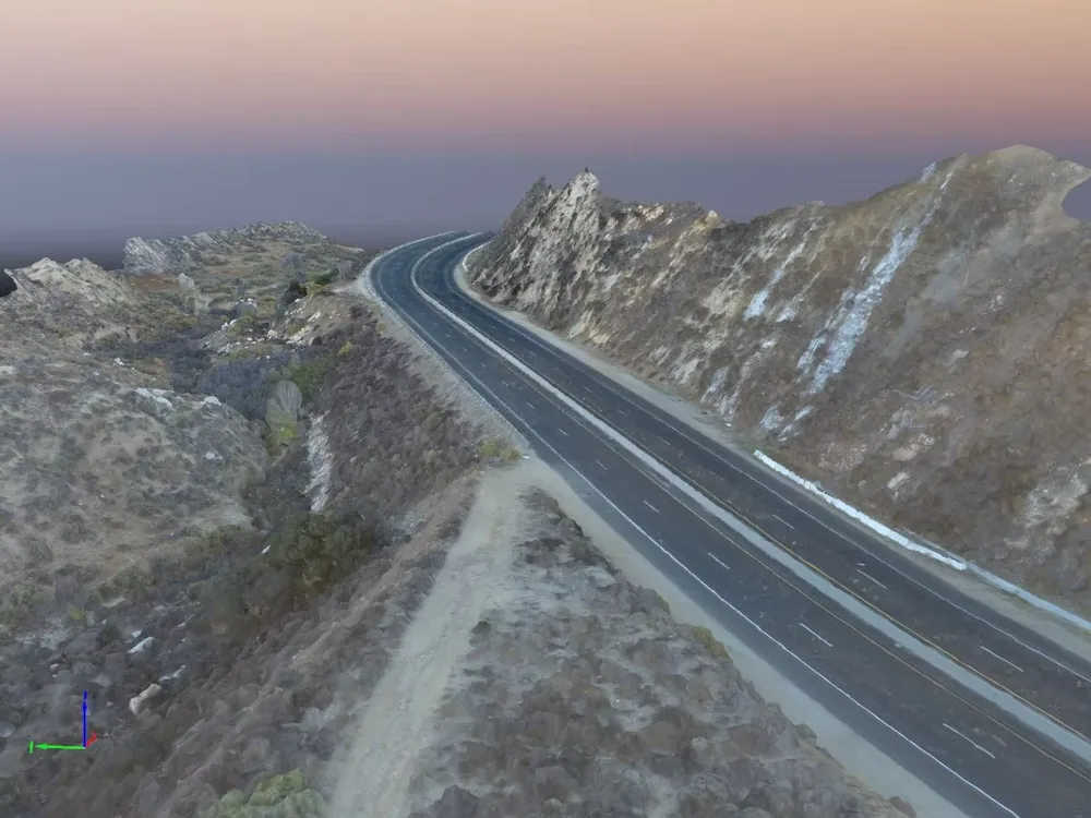 A textured mesh of a road running through hilly terrain