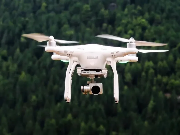 A drone in flight above trees