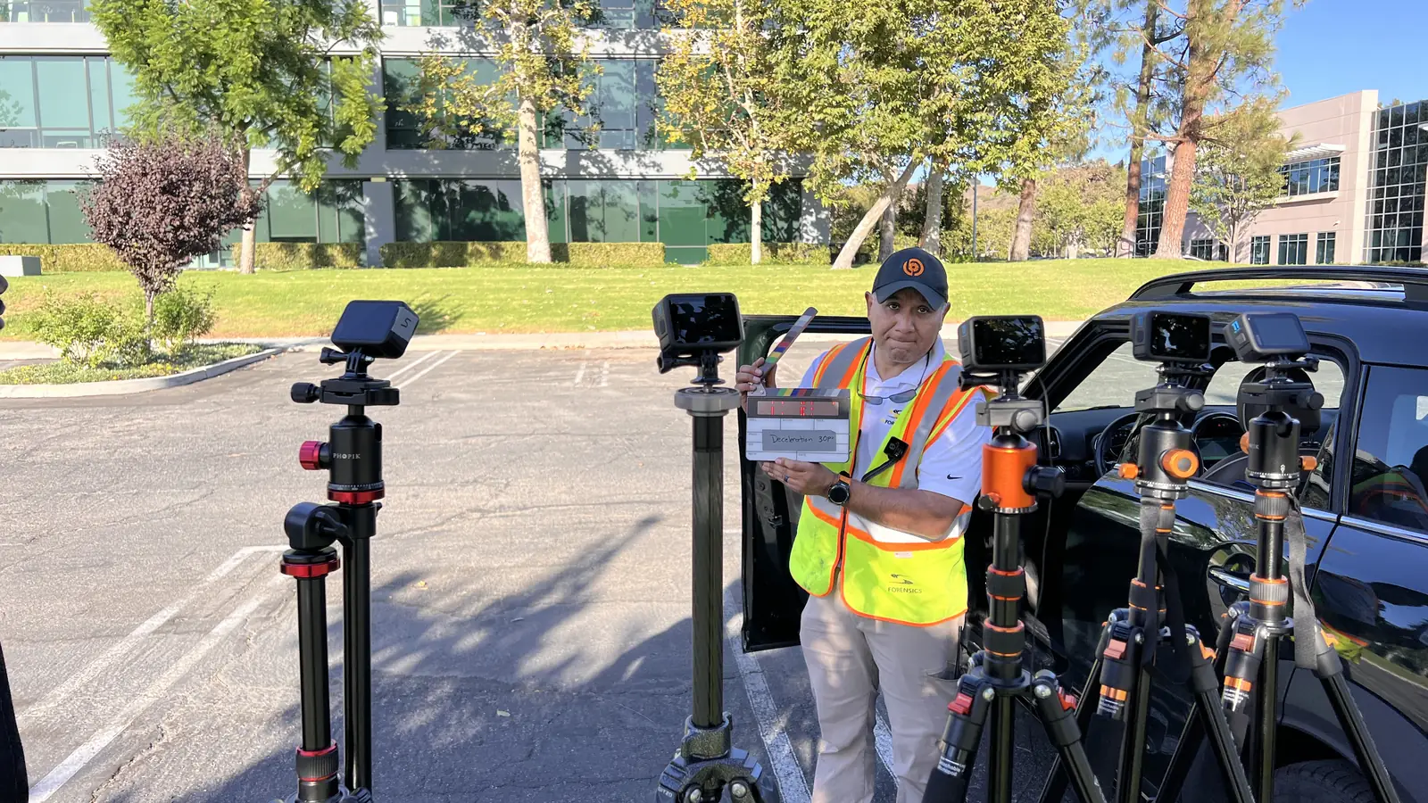 Cameras on tripods set up at a roadside
