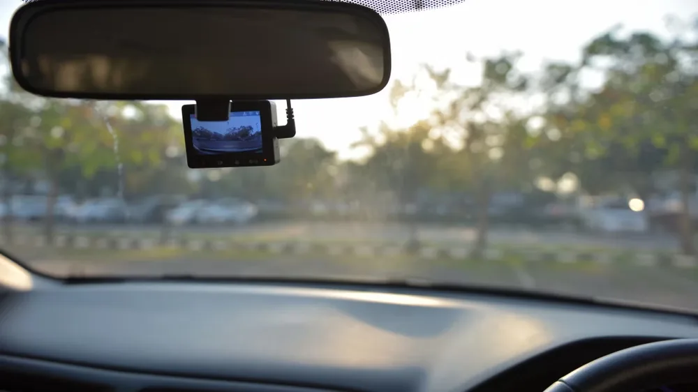 A dash camera mounted at a windshield