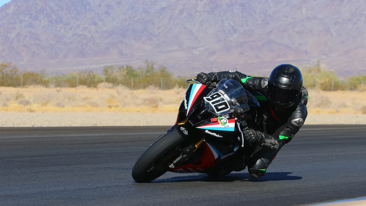 A rider cornering a motorcycle on a racetrack