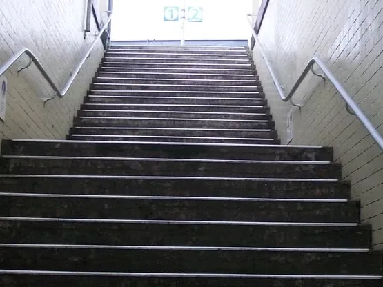 An outdoor stairway in a tiled underpass