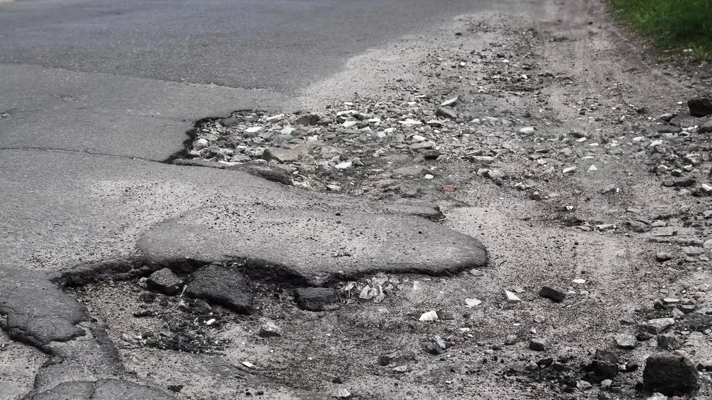 A pothole in a paved surface